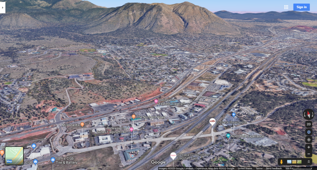 Desktop screenshot of Google Maps looking down a Flagstaff, AZ in 3D.